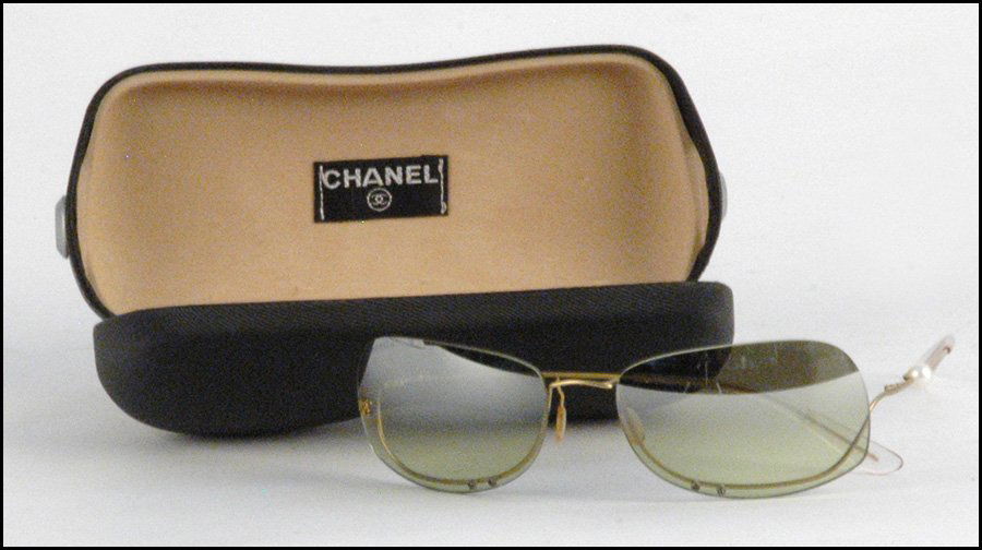 CHANEL SUNGLASSES.: CHANEL SUNGLASSES. Bearing a green tint, and a single cultured pearl along one arm. With original box