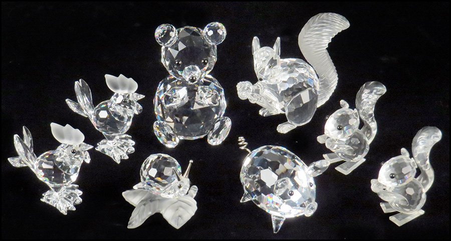 COLLECTION OF SWAROVSKI CRYSTAL ANIMALS.: COLLECTION OF SWAROVSKI CRYSTAL ANIMALS. Comprised of a pair of squirrels, a pair of roosters, a snail, a pig, a squirrel with an acorn, and a teddy bear. Includes pair of roosters, snail, pig, squirr