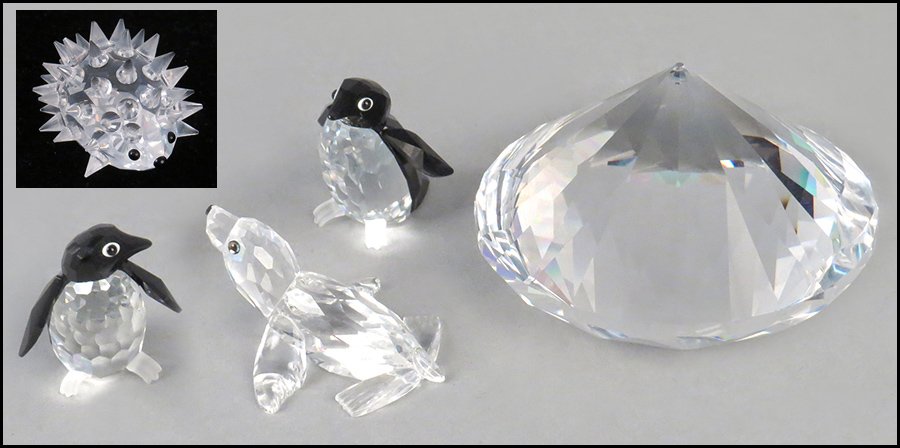 TWO SWAROVSKI CRYSTAL PENGUINS.: TWO SWAROVSKI CRYSTAL PENGUINS. Together with a Swarovski crystal seal, hedgehog, and diamond. Includes hedgehog and diamond with original boxes