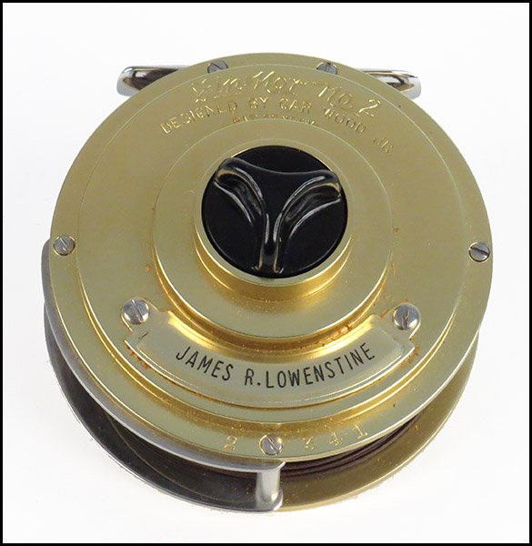 FIN-NOR WEDDING CAKE TWO-FLY REEL, 'THE SALMON'.: FIN-NOR WEDDING CAKE TWO-FLY REEL, 'THE SALMON'. Gold-plated. No. 2, 200 yards of 15# braided nylon, plus 40 yards of GAF fly line, #341. With case Overall: 4" x 6" x 6" (with case)