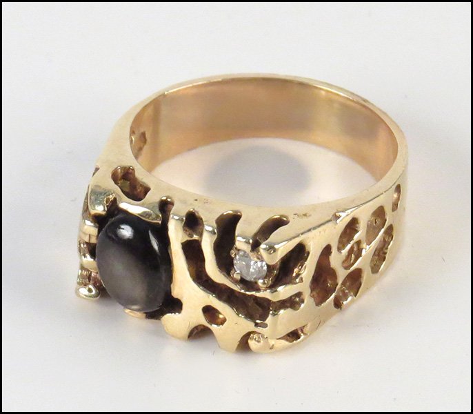 MAN'S YELLOW GOLD AND DIAMOND RING.: MAN'S YELLOW GOLD AND DIAMOND RING. Comprised of one round diamond, and one oval black star sapphire Wt: 10.7 g