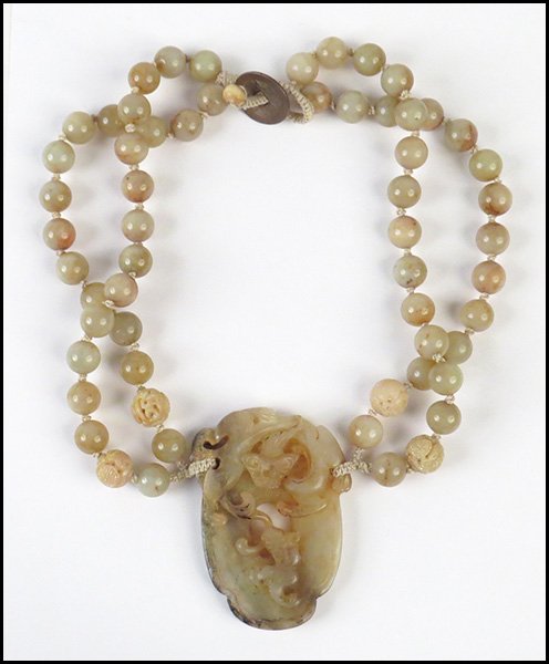 CHINESE CARVED SOAPSTONE NECKLACE.: CHINESE CARVED SOAPSTONE NECKLACE. Double strand jade bead necklace leads into a carved soapstone medallion depicting animals Length: 22"