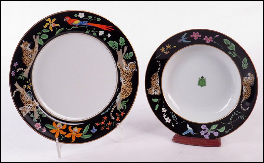 LYNN CHASE GILT PORCELAIN PARTIAL DINNER SERVICE.: LYNN CHASE GILT PORCELAIN PARTIAL DINNER SERVICE. In the Jaguar Jungle pattern. Comprised of thirteen dinner plates and twelve large rim soup bowls. Marked "1988 Lynn Chase Designs, Inc. Decorated wit