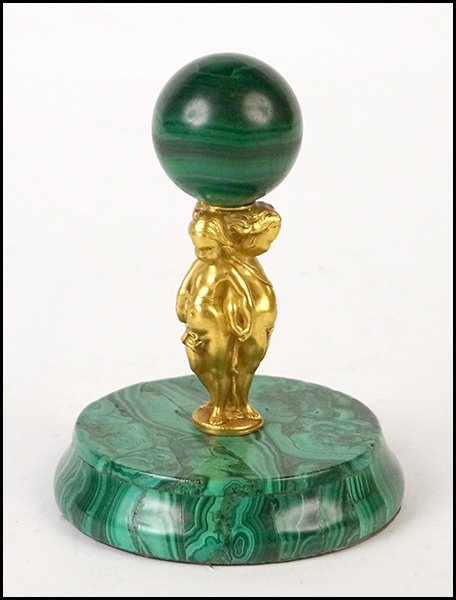 MALACHITE DESK ORNAMENT.: MALACHITE DESK ORNAMENT. Mounted with a trio of gilt metal putti Height: 4.5"