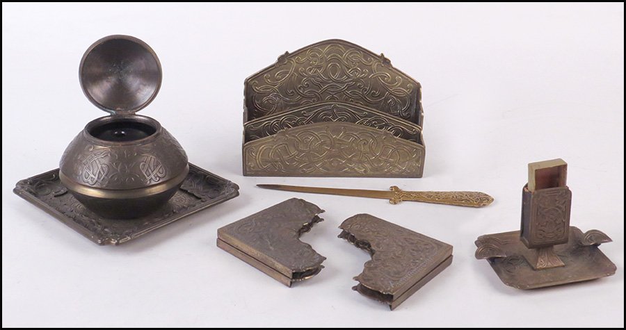 MARSHALL FIELD & CO. GILT METAL DESK SET.: MARSHALL FIELD & CO. GILT METAL DESK SET. In a Celtic knot motif. Comprised of an inkwell, letter rack, letter opener, tray, smoking stand, and four blotters