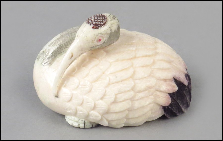 CARVED IVORY RECUMBENT CRANE NETSUKE.: CARVED IVORY RECUMBENT CRANE NETSUKE. Underside bears a two character signature 1.5" x 2" x 1.5"