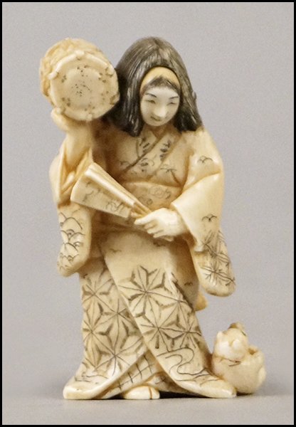 JAPANESE CARVED IVORY GEISHA NETSUKE.: JAPANESE CARVED IVORY GEISHA NETSUKE. With a convertible face Height: 2.75"