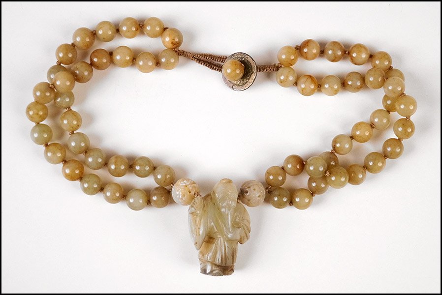 CHINESE TWO-STRAND NECKLACE.: CHINESE TWO-STRAND NECKLACE. Comprised of two strands of jade beads leading into a carved soapstone figure of an elder Length: 21"