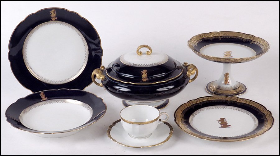 A FRENCH GILT PORCELAIN DINNER SERVICE.: A FRENCH GILT PORCELAIN DINNER SERVICE. Comprised of twenty-four cobalt border plates (diameter: 9.75"), twelve gilt border plates (diameter: 9.75"), twelve soup bowls, a pair of compotes, and a cover