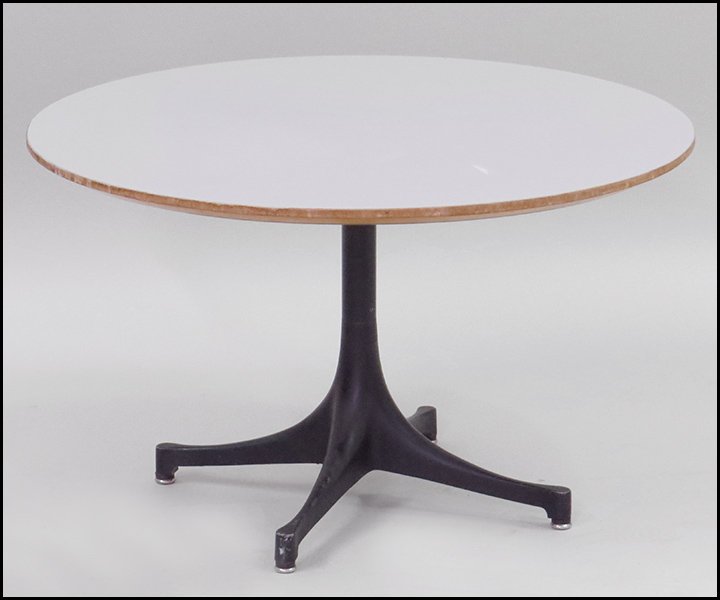 GEORGE NELSON FOR HERMAN MILLER SIDE TABLE.: GEORGE NELSON FOR HERMAN MILLER SIDE TABLE. Bearing a white laminate top with a black metal base H: 17'' Diameter: 28''