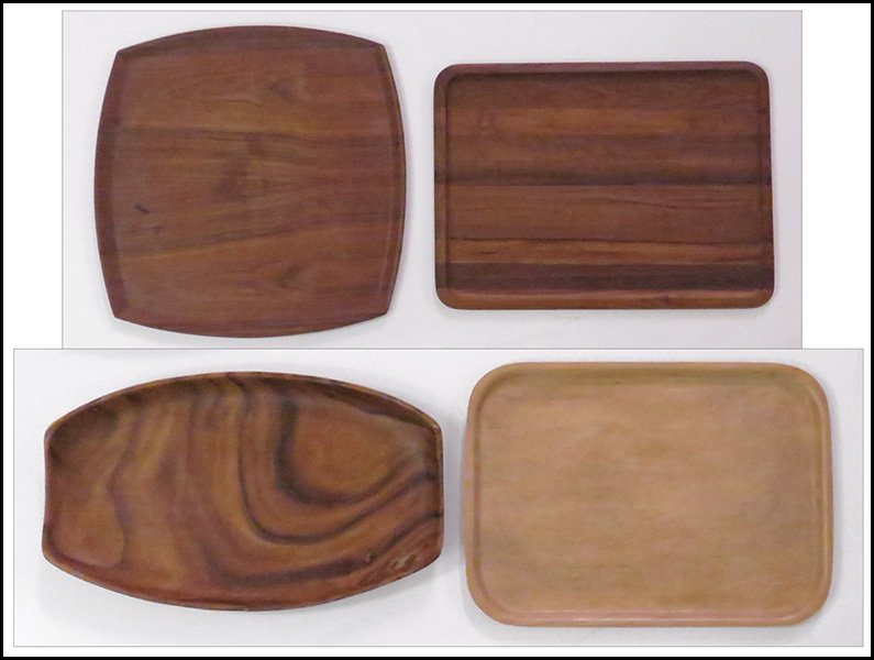 GROUP OF FOUR CARVED TEAK TRAYS.: GROUP OF FOUR CARVED TEAK TRAYS. One stamped "Form AB Made in Sweden," one stamped "Kent Kraft Made in Sweden by Silva," one unmarked, and one marked illegibly Largest tray: 23.5'' x 14''