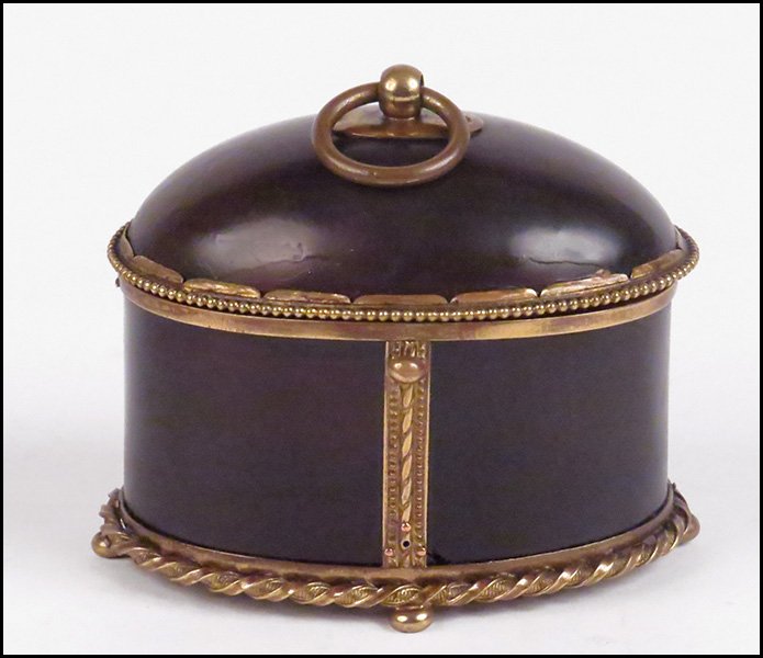 A CONTINENTAL 19TH CENTURY TORTOISESHELL AND BRASS BOX.: A CONTINENTAL 19TH CENTURY TORTOISESHELL AND BRASS BOX. Lid formed by a beaded edge, with lift top ring. Lower portion bears twisted brass forming the lower perimeter, a push button closure, and bun f