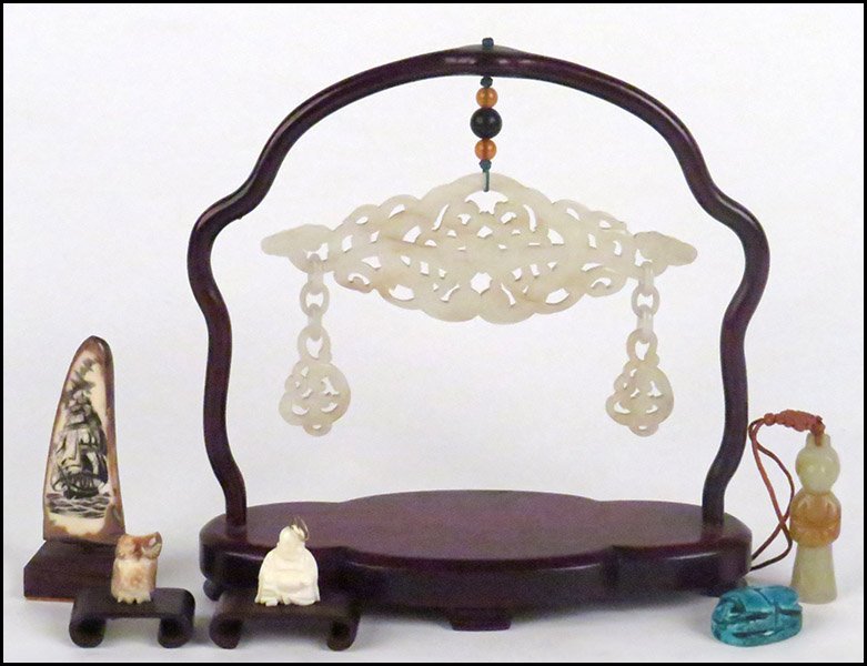 CARVED JADE PANEL.: CARVED JADE PANEL. Together with a blue glazed ceramic scarab, a carved ivory buddha pendant, a carved bone owl, a carved stone figural pendant, and a scrimshaw