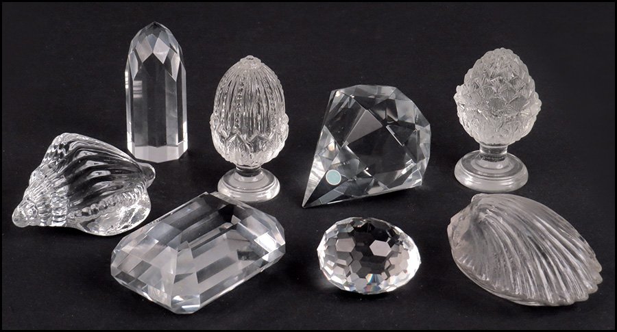 COLLECTION OF EIGHT PAPERWEIGHTS.: COLLECTION OF EIGHT PAPERWEIGHTS. Comprised of a Tiffany & Co. diamond form, an unsigned Tiffany & Co. emerald-cut form, a Swarovski egg, two unsigned seashells, two unsigned plant forms, and an unsig