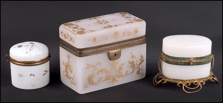 THREE OPALINE HINGED LID BOXES.: THREE OPALINE HINGED LID BOXES. One large rectangular box with brass mountings and gilt decoration, one oval shaped with brass mountings, scrollwork feet, and free moving handles, and one smaller roun