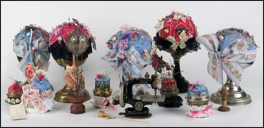 MINIATURE SINGER SEWING MACHINE.: MINIATURE SINGER SEWING MACHINE. Together with a Sterling silver stitch ripper, three thimbles, a button hook, assorted oil lamps converted into pin cushions, and assorted hat pins 6.5" x 7"