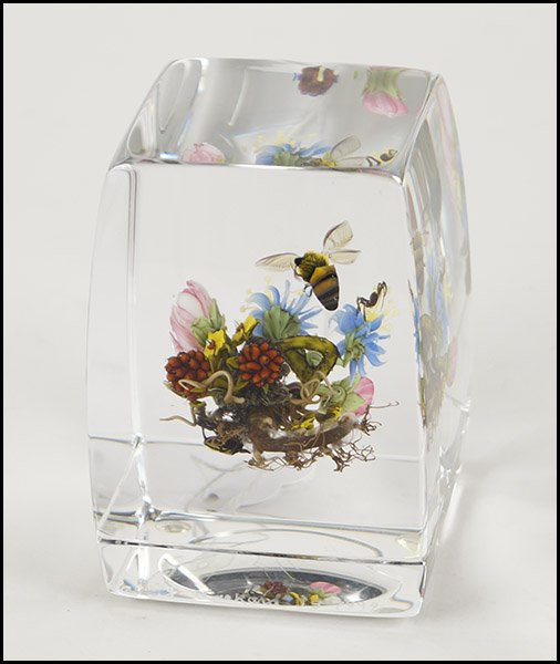 PAUL STANKARD (AMERICAN, B. 1943) UNTITLED CUBE PAPERWE: PAUL STANKARD (AMERICAN, B. 1943) UNTITLED CUBE PAPERWEIGHT. Lampwork paperweight depicts flowers in bloom with a bumble bee atop and a spider below. Side bears etched signature "Paul J. Stankard J3 1