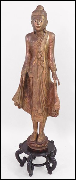 TRIPAR ANTIQUE THAI GILTWOOD FIGURE.: TRIPAR ANTIQUE THAI GILTWOOD FIGURE. Raised on a painted wood stand Figure H: 62.5''