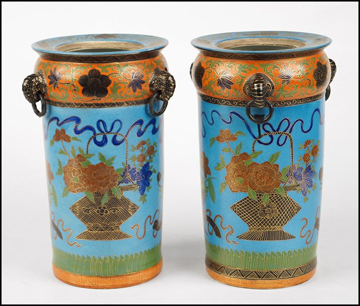 PAIR OF HAND PAINTED CHINESE URNS.: PAIR OF HAND PAINTED CHINESE URNS. Blue ground with handpainted baskets of flowers, gilt detailing, and three free moving porcelain handles each. Both are signed on undersides Each: 12" x 7"