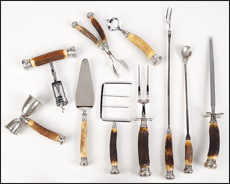 A COLLECTION OF BAR TOOLS AND SERVING PIECES.: A COLLECTION OF BAR TOOLS AND SERVING PIECES. Comprised of a corkscrew, carving knife, knife sharpener, cake knife, bottle opener, cake break, double jigger, a cocktail stir, a roasting utensil, and a