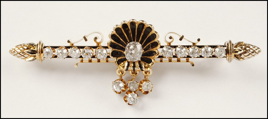 DIAMOND AND 14 KARAT YELLOW GOLD BAR BROOCH.: DIAMOND AND 14 KARAT YELLOW GOLD BAR BROOCH. Center of brooch is comprised of a black enamel shell with an oval diamond and four round diamonds suspended from it. Leading out from the center are five 