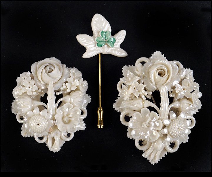 TWO BELLEEK PARIAN PORCELAIN FLORAL BROOCHES.: TWO BELLEEK PARIAN PORCELAIN FLORAL BROOCHES. Together with a Belleek porcelain shamrock stick pin Larger pin diameter: 2.5"