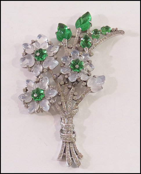 A TRIFARI RHINESTONE AND GLASS FUR CLIP.: A TRIFARI RHINESTONE AND GLASS FUR CLIP. Faux moonstone and green glass form the leaves and blooms 4.75" x 3.5"