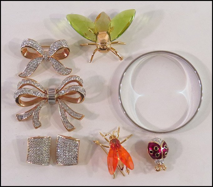TWO SWAROVSKI INSECT BROOCHES.: TWO SWAROVSKI INSECT BROOCHES. Together with a Swarovski enamel ladybug pin, two rhinestone bow brooches, a pair of rhinestone earclips, and a Monet silvertone bangle bracelet