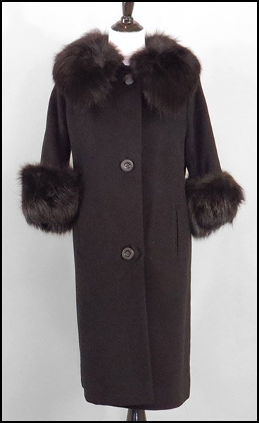 BLACK WOOL SWING COAT.: BLACK WOOL SWING COAT. With slash pockets. Trimmed in fox at the collar and cuffs. Labeled Estelle Albus, Marion, PA Size 4/6