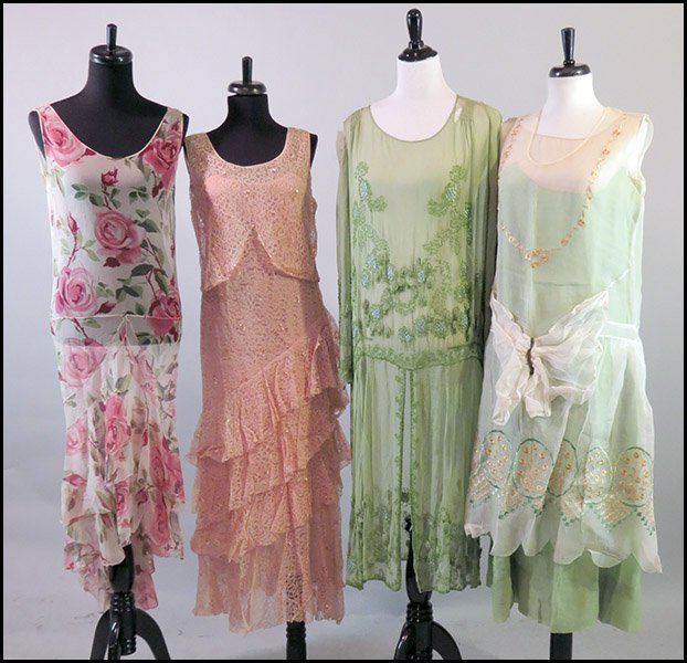 COLLECTION OF 1920'S AND 1930'S DRESSES.: COLLECTION OF 1920'S AND 1930'S DRESSES. Comprised of a pink lace and sequins drop waist dress, a pink floral chiffon dress, a green beaded chiffon dress with a built in slip, and an embroidered organ