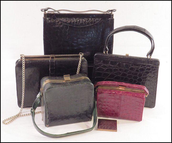 COLLECTION OF ALLIGATOR HANDBAGS.: COLLECTION OF ALLIGATOR HANDBAGS. Comprised of one black horned back alligator bag, two unlabeled black bags, one green structured bag, one red structured bag, and a brown alligator skin covered compa