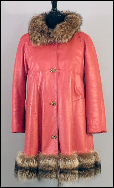 BONNIE CASHIN ORANGE LEATHER COAT.: BONNIE CASHIN ORANGE LEATHER COAT. Bearing a white "Sills" label, fur lining, and raccoon fur trim on the neckline and along the bottom Size: Medium