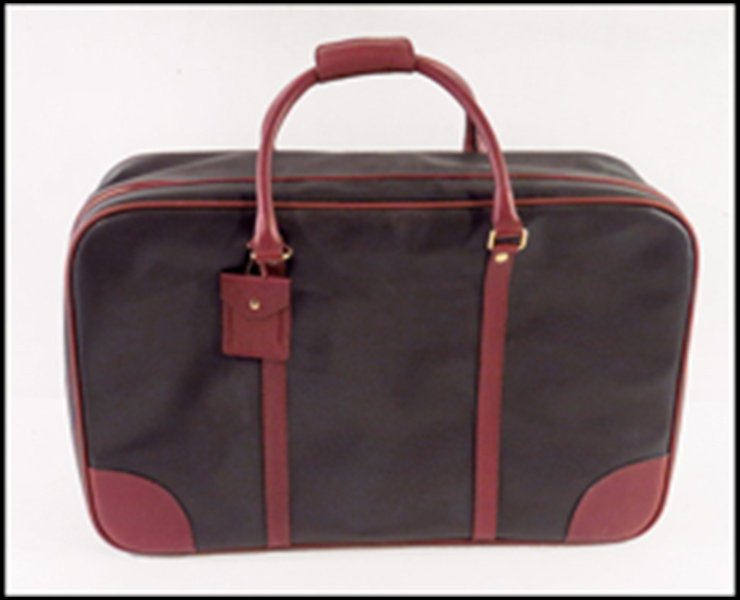BOTTEGA VENETA BLACK AND BROWN LEATHER SOFTSIDED: BOTTEGA VENETA BLACK AND BROWN LEATHER SOFTSIDED SUITCASE. With quilted interior. Stamped "Bottega Veneta Made in Italy." Bearing a leather luggage tag 16'' x 25'' x 6''