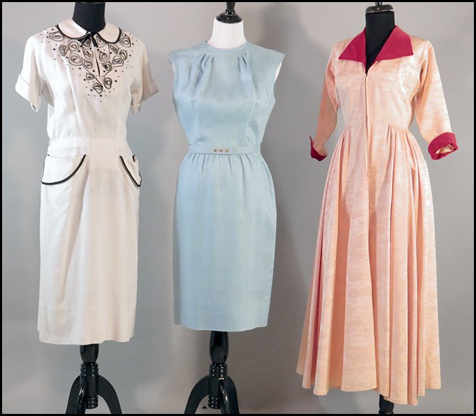 EISENBERG ORIGINALS WHITE LINEN DRESS.: EISENBERG ORIGINALS WHITE LINEN DRESS. Bearing two pockets, black piping, and the Eisenberg label. Together with a Robert Rosenfeld 1950's era "Lucy" dress and an Adele Martin / Bonwit Teller blue lin