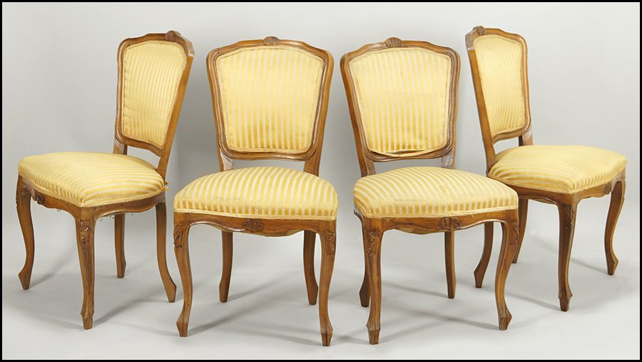 SET OF FOUR FRENCH CARVED WALNUT SIDE CHAIRS.: SET OF FOUR FRENCH CARVED WALNUT SIDE CHAIRS. Bearing scallop shell design at the crest and apron. With ball and claw feet 35" x 20" x 17"