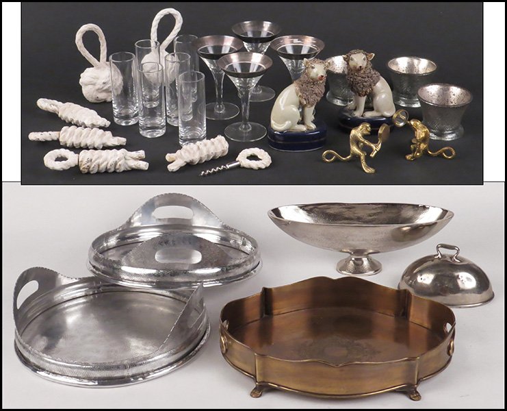 COLLECTION OF DECORATIVE TABLE ARTICLES.: COLLECTION OF DECORATIVE TABLE ARTICLES. Comprised of two round metal trays, an oval brass tray, an oval, pedestal form center bowl, a handled dome, two brass monkey forms holding mirrors, two painted