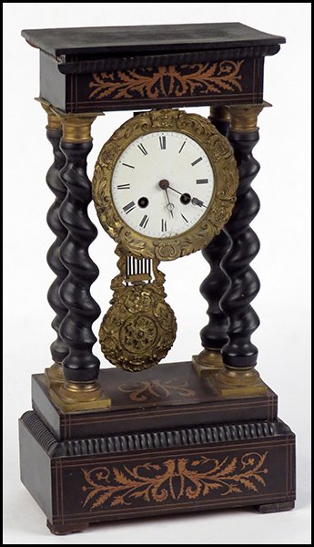 EBONIZED AND GILTWOOD CLOCK.: EBONIZED AND GILTWOOD CLOCK. Movement stamped "Japy Freres." Together with a key and pendulum. Raised on a 3'' wood base H: 13.25''