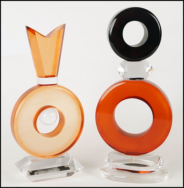 TWO VAN TEAL CLEAR AND COLORED LUCITE PERFUME BOTTLE: TWO VAN TEAL CLEAR AND COLORED LUCITE PERFUME BOTTLE FORM SCULPTURES. Taller of the two is signed, the other is not Taller: 13"