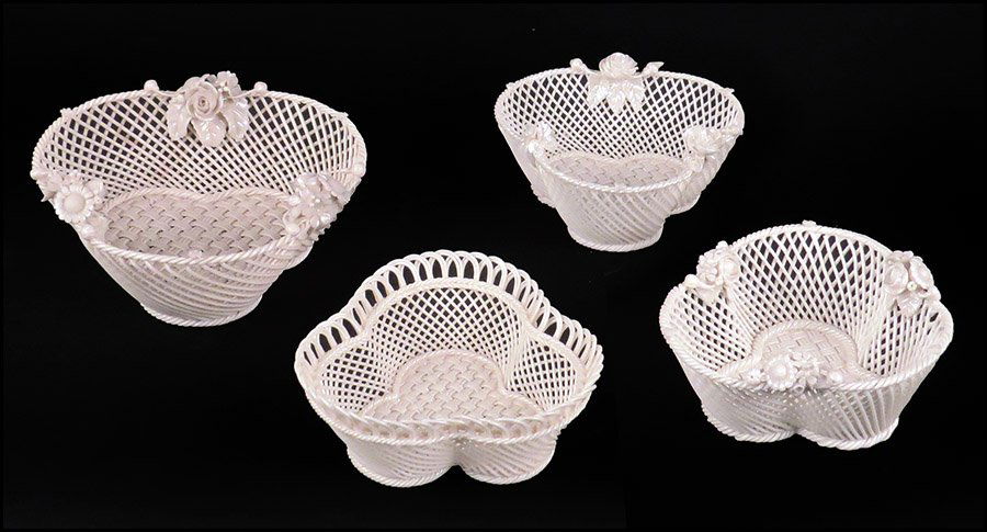FOUR BELLEEK PORCELAIN TREFOIL SHAPED BASKETS.: FOUR BELLEEK PORCELAIN TREFOIL SHAPED BASKETS. Three bearing applied floral decoration and one with with a basket weave rim. All bear the Belleek imprint on the undersides Largest: 2.5" x 6" Smaller t