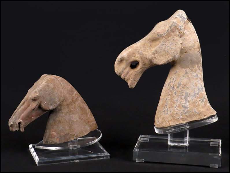 TWO HAN DYNASTY STYLE CERAMIC HORSE HEADS.: TWO HAN DYNASTY STYLE CERAMIC HORSE HEADS. With custom lucite stands Larger horse head H: 9''