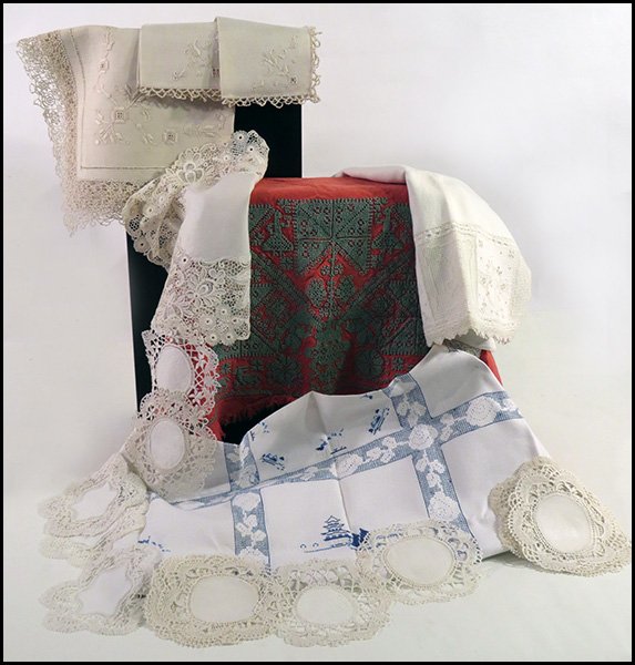 COLLECTION OF EARLY 19TH CENTURY WHITE TABLE LINENS.: COLLECTION OF EARLY 19TH CENTURY WHITE TABLE LINENS. Comprised of linen, lace, silk, and cotton table cloths, napkins, doilies, and placemats. Some embroidered. Together with pillow cases, pillow sham
