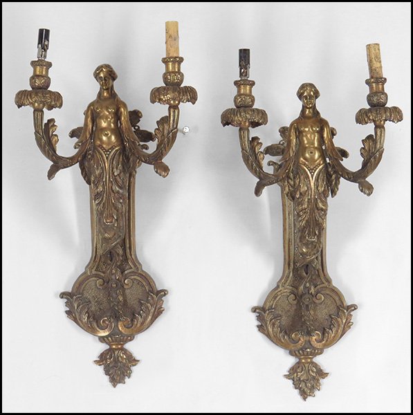 PAIR OF PATINATED BRONZE TWO-LIGHT FIGURAL WALL: PAIR OF PATINATED BRONZE TWO-LIGHT FIGURAL WALL SCONCES. Depicting a nude female figure and acanthus, wired for electricity 22" x 12"