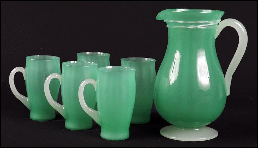 STEUBEN JADE AND ALABASTER LEMONADE SET.: STEUBEN JADE AND ALABASTER LEMONADE SET. Comprised of a pitcher and five handled cups, bottom of the pitcher bears the acid etched banner mark Pitcher: 10.5" Cup: 5.5"