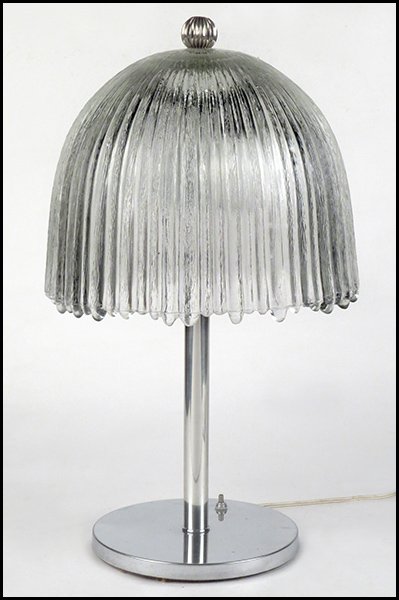 PRESSED GLASS AND METAL TABLE LAMP.: PRESSED GLASS AND METAL TABLE LAMP. Silvertone base with an umbrella form shade 20" x 12"
