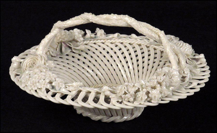 BELLEEK PORCELAIN HANDLED BASKET.: BELLEEK PORCELAIN HANDLED BASKET. Two-strand basket bearing applied flowers with lightly painted and glazed leaves and the Belleek 1st period impressed mark on underside 5" x 9.5"
