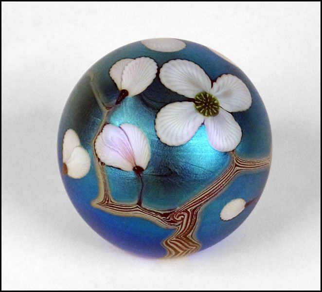 BRUCE SILLARS FOR ORIENT & FLUME PAPERWEIGHT.: BRUCE SILLARS FOR ORIENT & FLUME PAPERWEIGHT. Iridescent turqouise ground bearing a flowering tree design with white flowers. Underside is signed and dated July 1981 3" x 3"