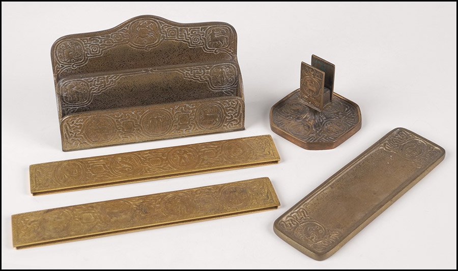 TIFFANY STUDIOS GILT BRONZE DESK ACCESSORIES.: TIFFANY STUDIOS GILT BRONZE DESK ACCESSORIES. Comprised of a pair of blotters (12.25" x 2"), a pen tray (10" x 3"), a letter rack (6" x 9.5" x 2.25"), and a match holder (3.5" x 4.5" x 4.5"). All piec