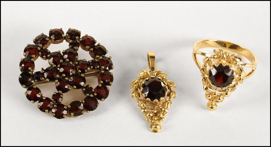 GARNET AND 14 KARAT YELLOW GOLD DEMI-PARURE.: GARNET AND 14 KARAT YELLOW GOLD DEMI-PARURE. Comprised of a pendant and ring. Together with a Czech garnet circle brooch Ring size: 7.5