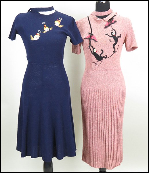 TWO MIMI PEARCE NEW YORK HANDKNIT SHORT SLEEVE DRESSES.: TWO MIMI PEARCE NEW YORK HANDKNIT SHORT SLEEVE DRESSES. One blush pink, bearing a monkey motif, a self belt, and a Peter Pan collar. One navy, bearing an angel motif. Both with dropped waists Sizes un