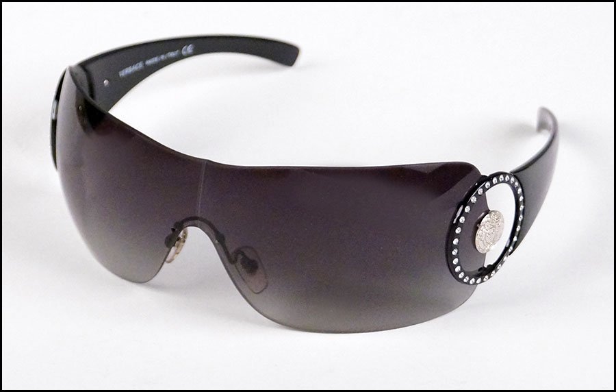 VERSACE SUNGLASSES.: VERSACE SUNGLASSES. Made in Italy. Bearing rhinestone embellishments and the signature Versace insignia with the Greek key and Medusa head. In their original case